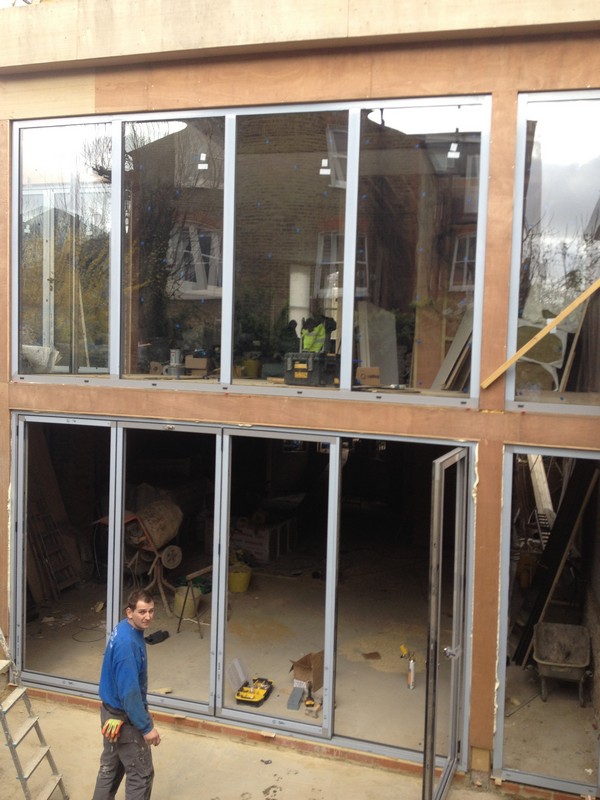 Aluminium bi-fold doors with two-storey glazing in Surbiton