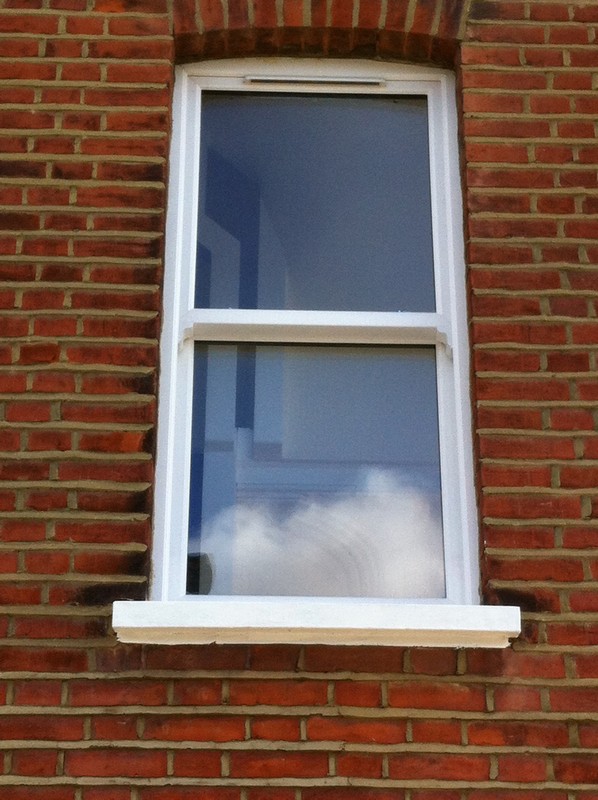 uPVC sash window on Victorian red brick house in Surbiton